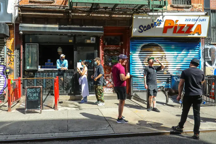 People order take out and drinking on the sidewalk, May 2020